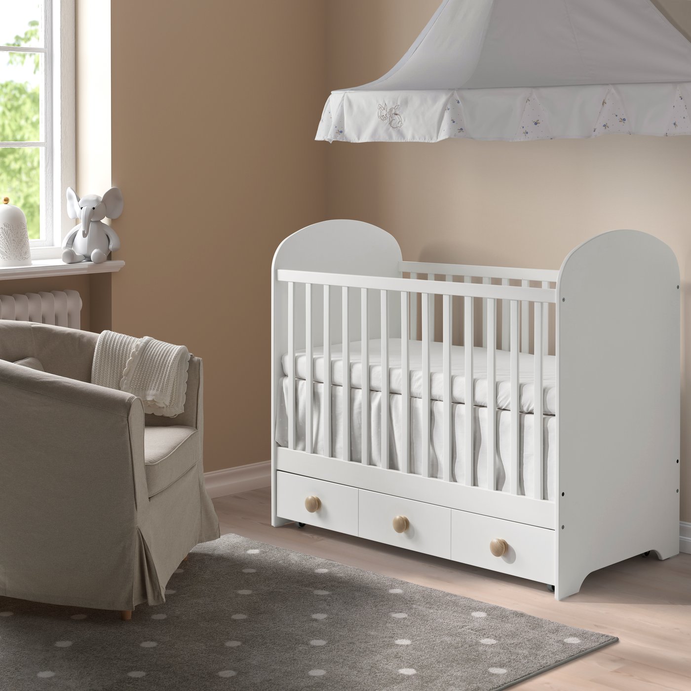 A white GONATT cot with drawer