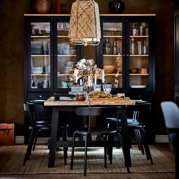 An acacia/black SKOGSTA dining table in the dining room