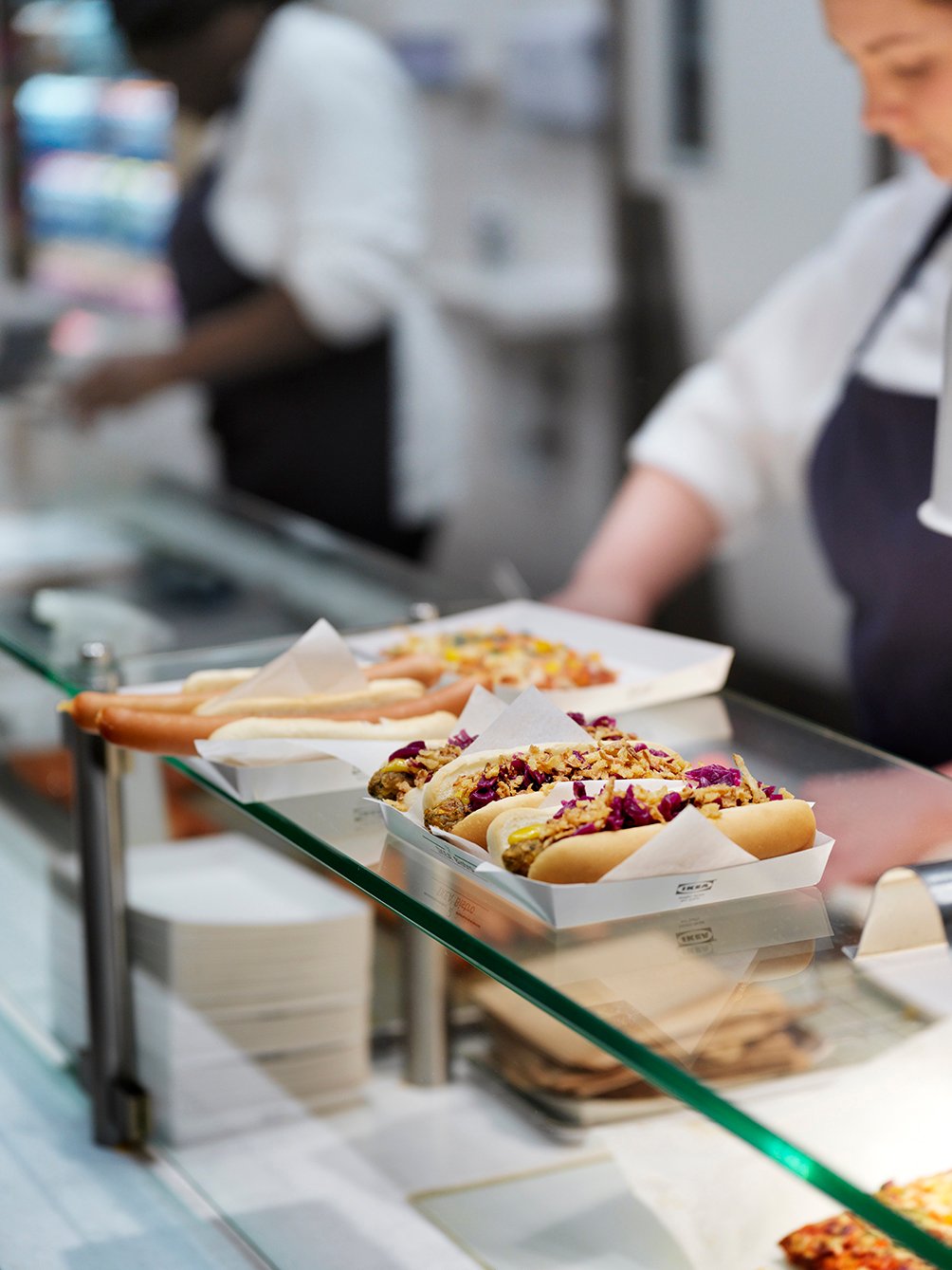 Freshly prepared hot dogs and meals served at a food counter, ready for a quick and tasty break during your visit.