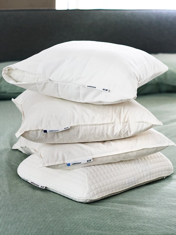 Una pila de 4 almohadas IKEA: MJÖLKKLOCK, LUNDTRAV. Y un cojín LUDDROS.