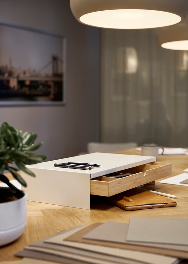 A white ELLOVEN monitor stand with drawer