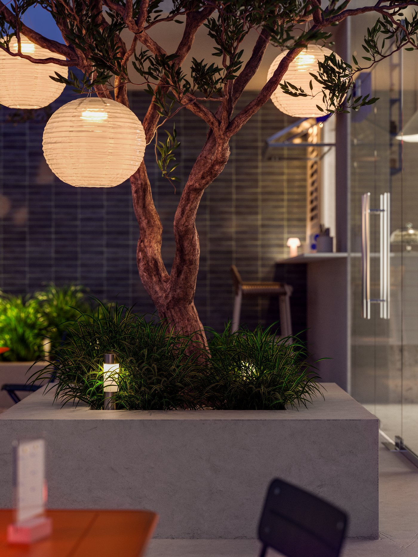 A café with an outdoor space in a warm evening light. Three SOLVINDEN LED solar pendant lamp hang in a tree.