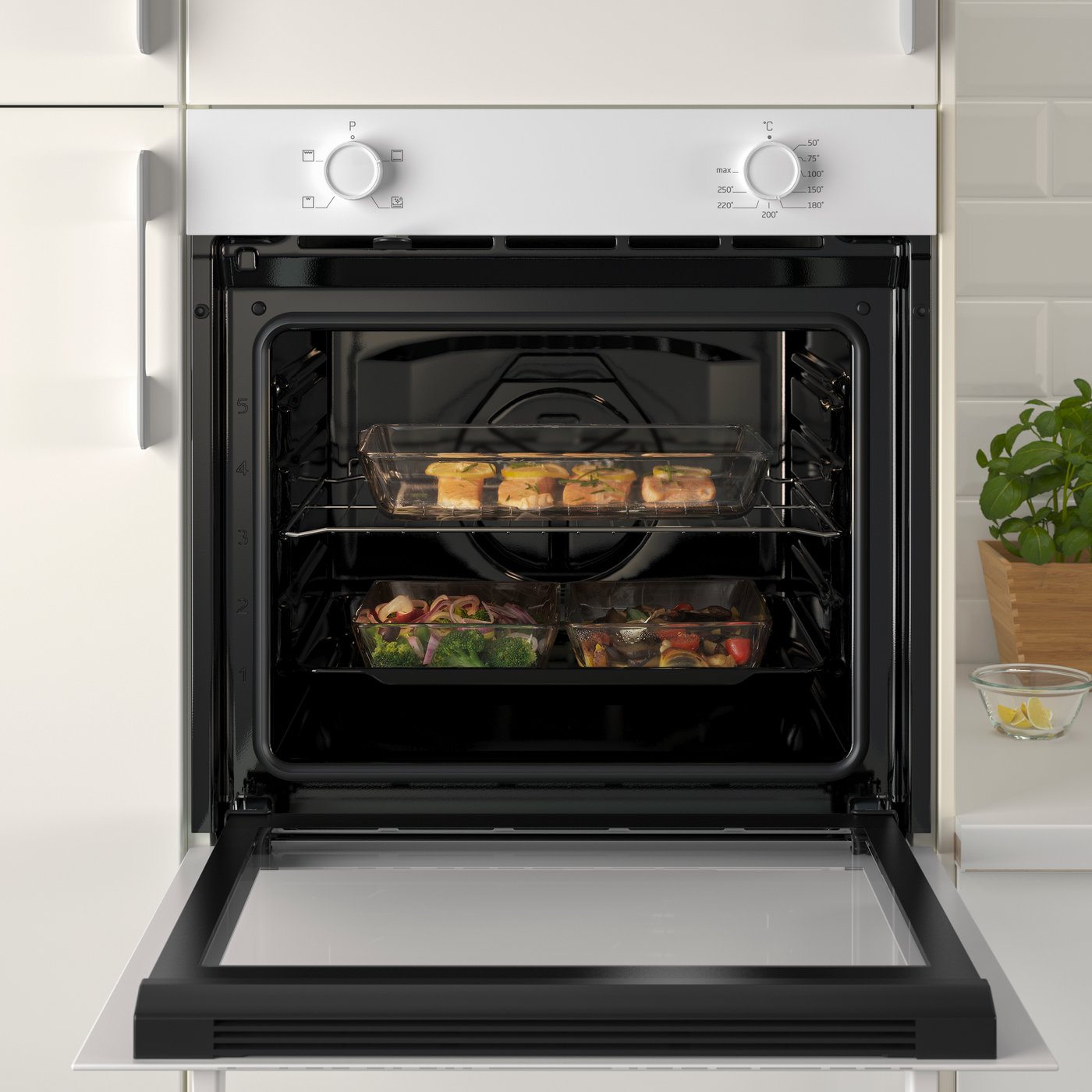 A LAGAN white oven integrated within a white kitchen with white handles and a white worktop