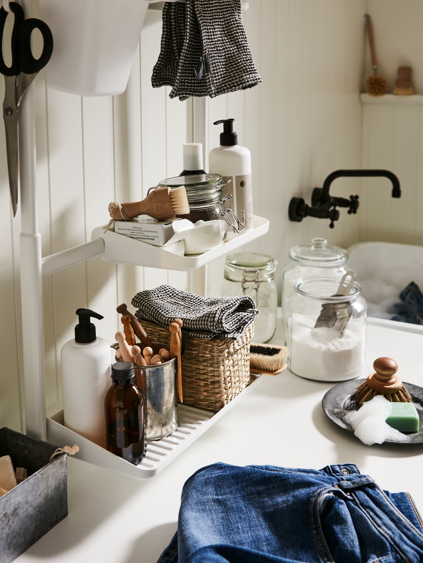 A clear glass VARDAGEN jar with lid in the bathroom