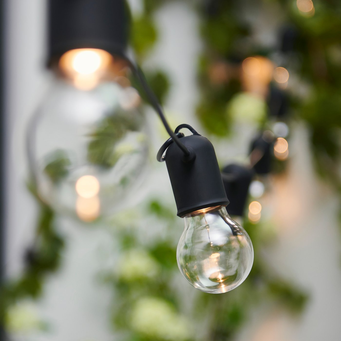un gros plan sur une guirlande lumineuse dans le jardin
