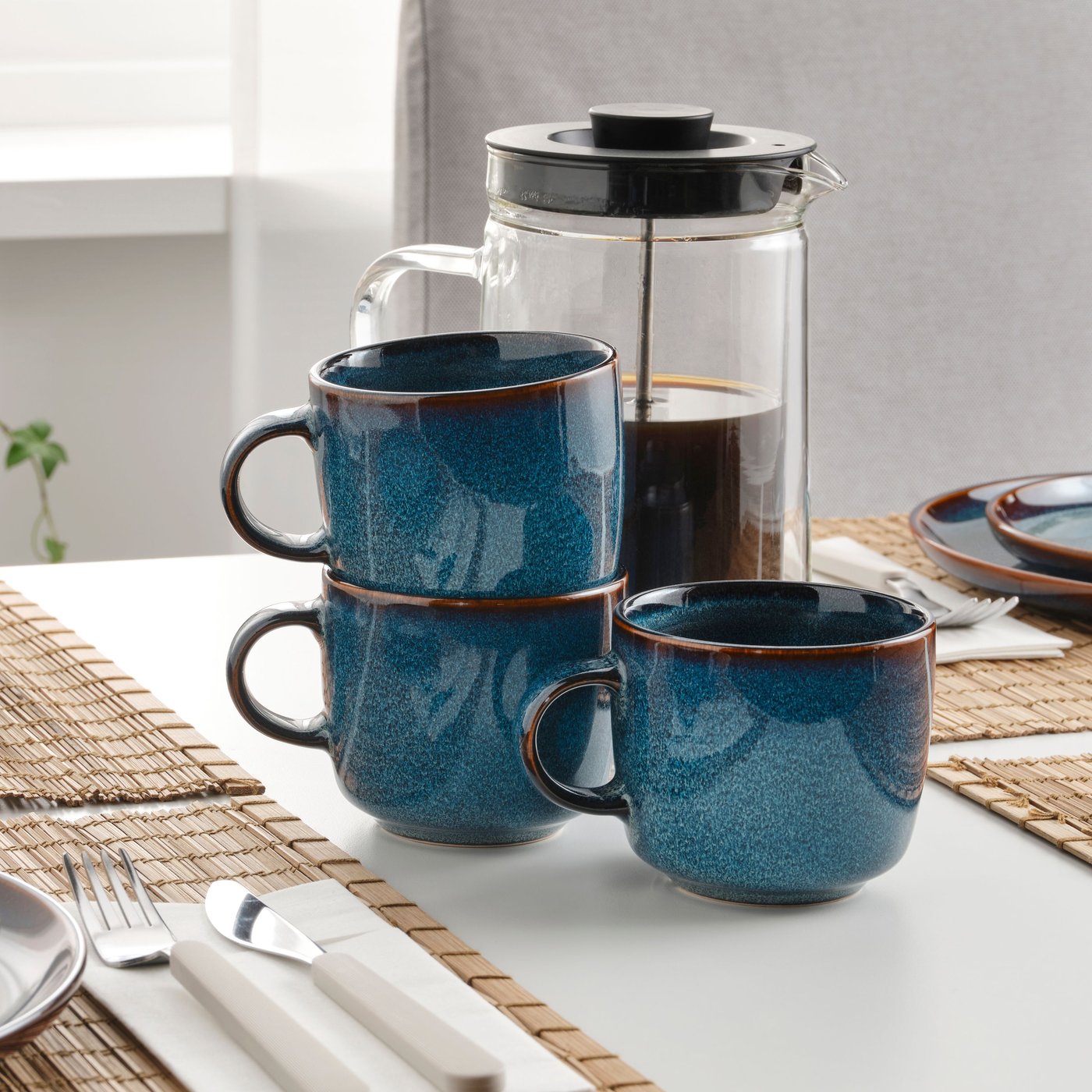 A blue GLADELIG mug in the dining room