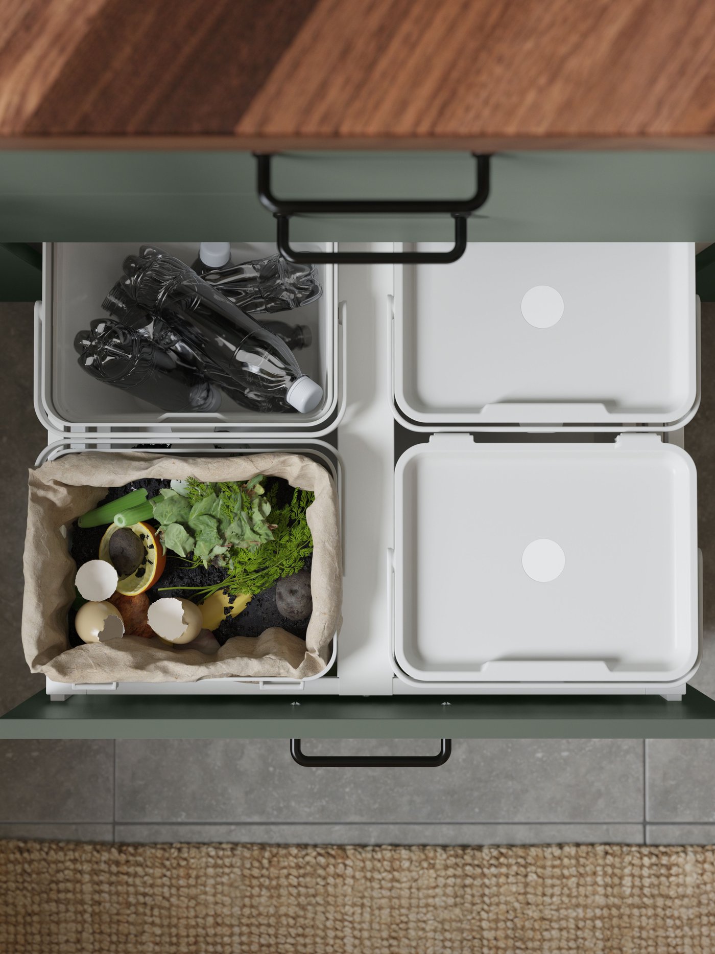 Garbage sorting from IKEA where a person has pulled out the boxes where you can see four different sorting boxes.