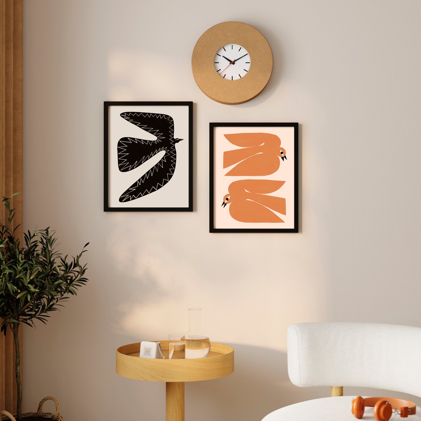 Wall with 2 posters of birds in black photo frames.
