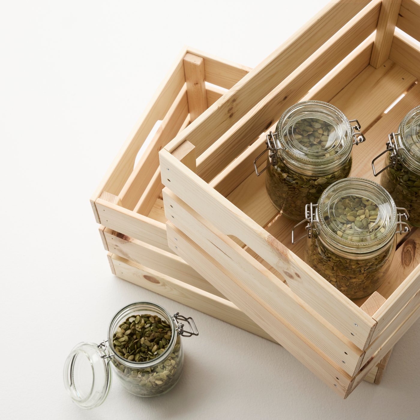 Close-up of a KNAGGLIG wood box, seen from above and containing glass jars with baking ingredients.