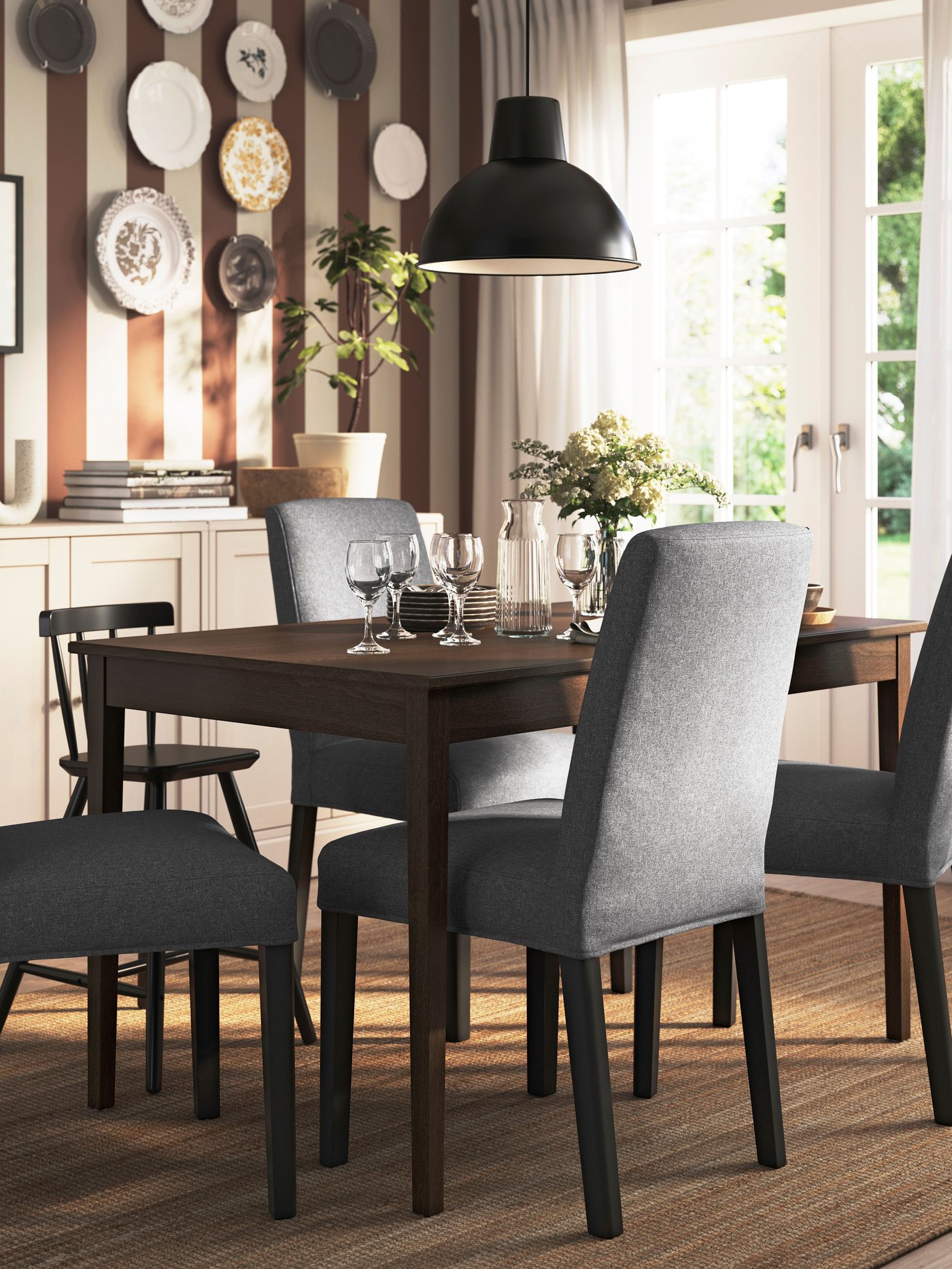 A black AGAM junior chair in the dining room.
