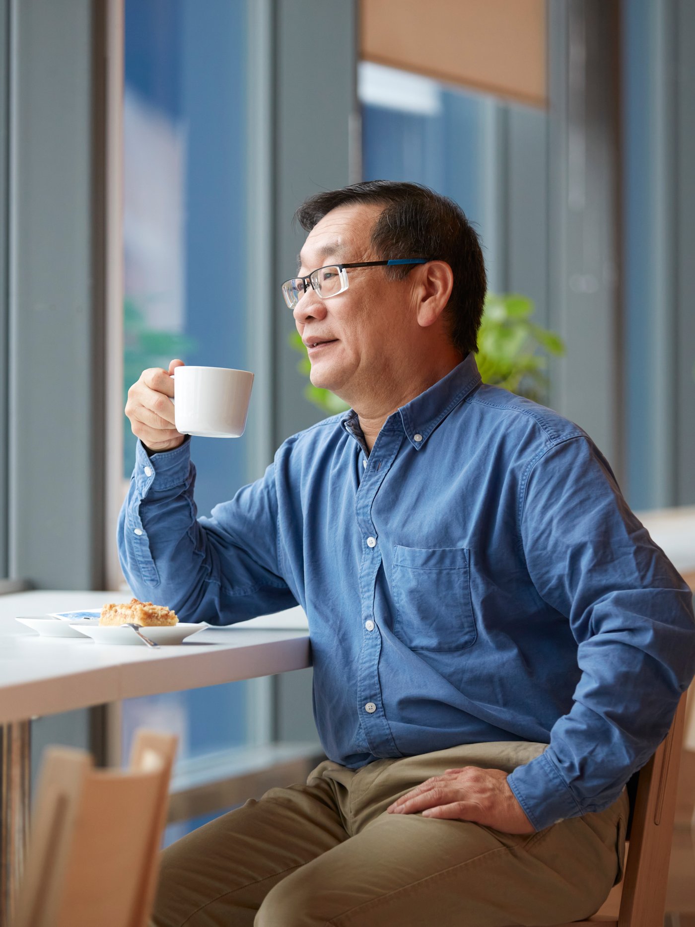  A man in the Swedish Restaurant drinking coffee.