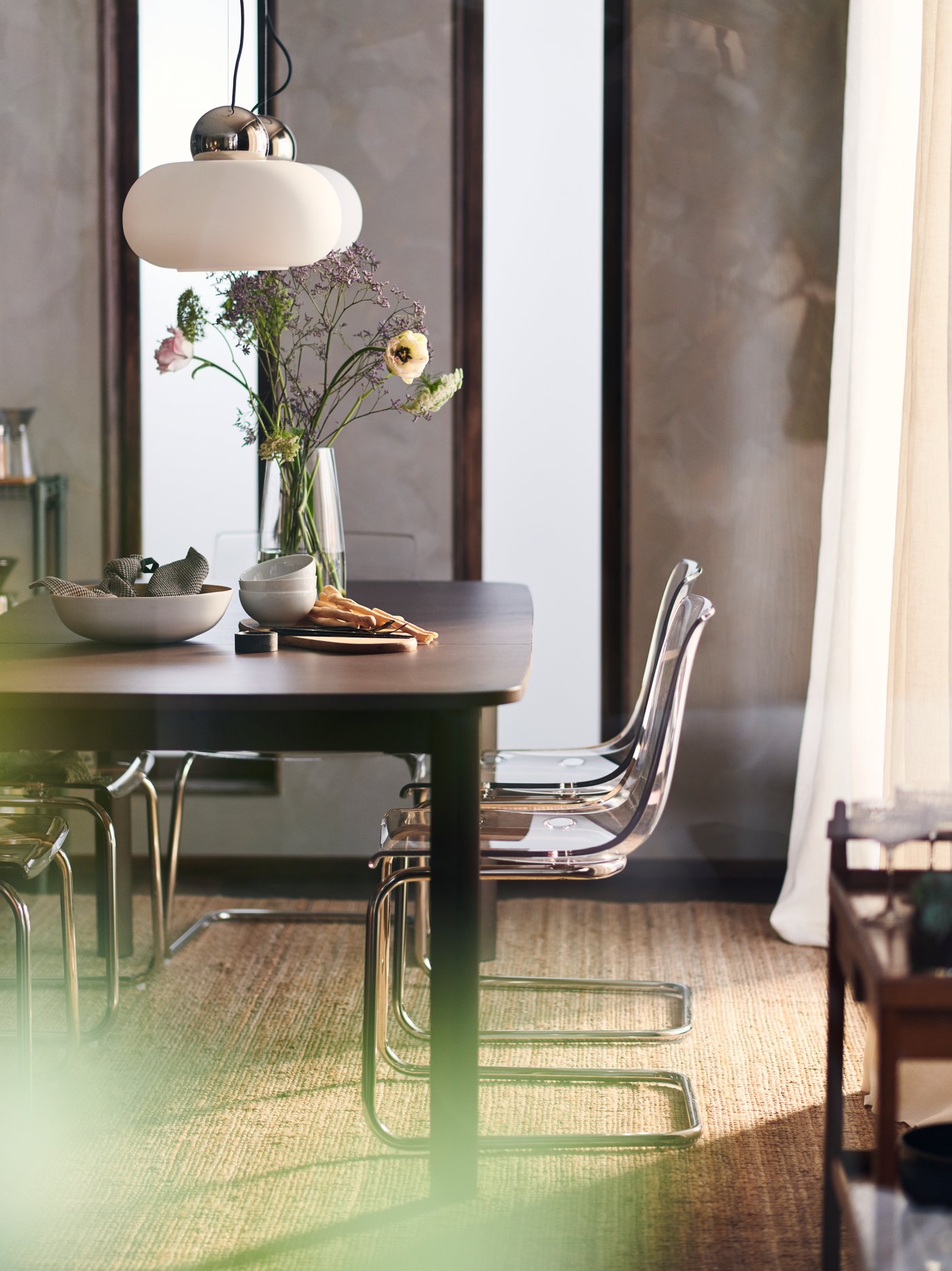A chrome-plated/opal white glass DEJSA pendant lamp in the dining room