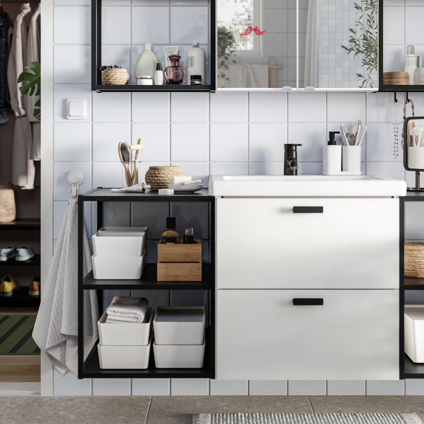 A bathroom with an ENHET vanity sink cabinet with 2 drawers, several open frames with shelves and two mirror doors.
