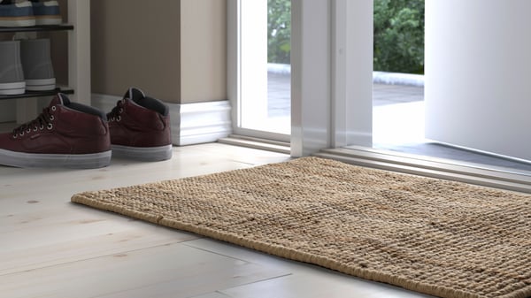 A natural LOHALS door mat, indoor