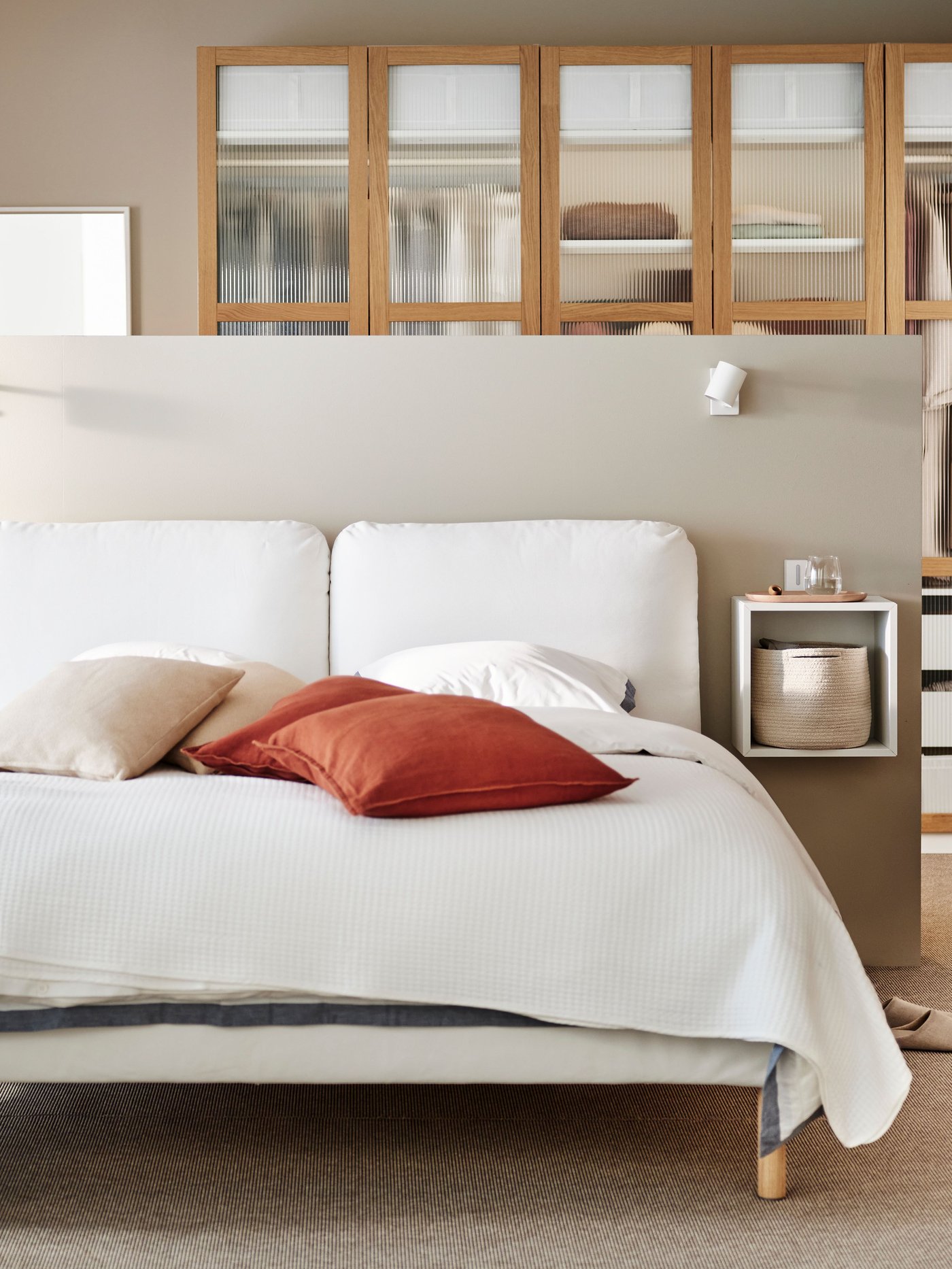 A red-brown DYTÅG cushion cover in the bedroom