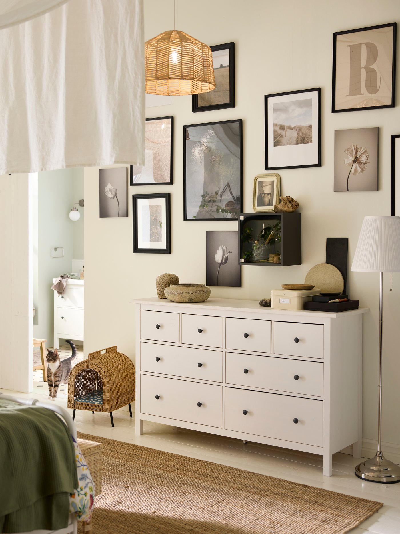 A white stain HEMNES chest with 8 drawers with various objects on top and an UTSÅDD cat house on legs beside it.