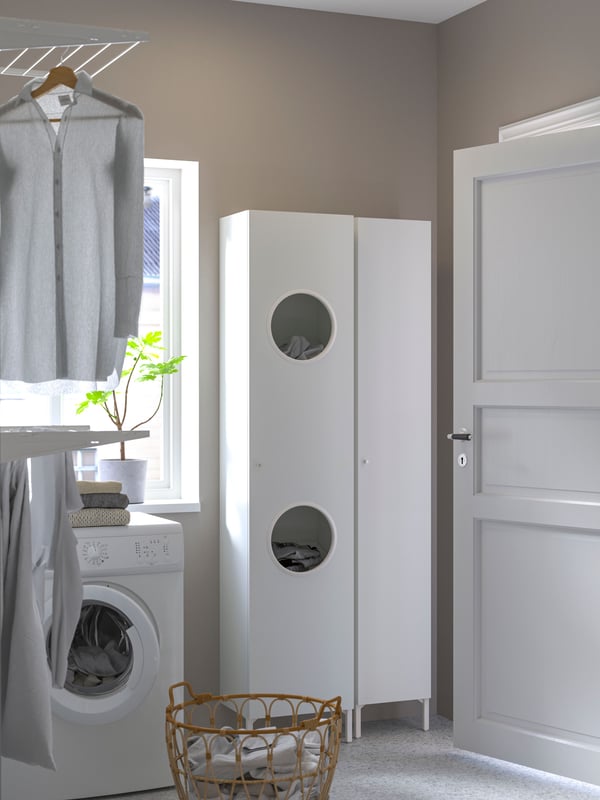 A white NYSJÖN laundry cabinet