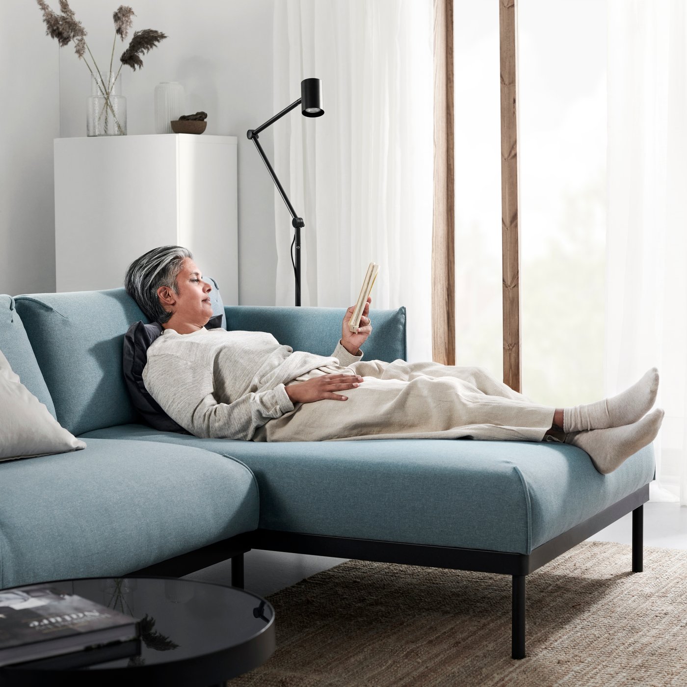 A Gunnared light blue ÄPPLARYD 3-seat sofa with chaise longue in the living room