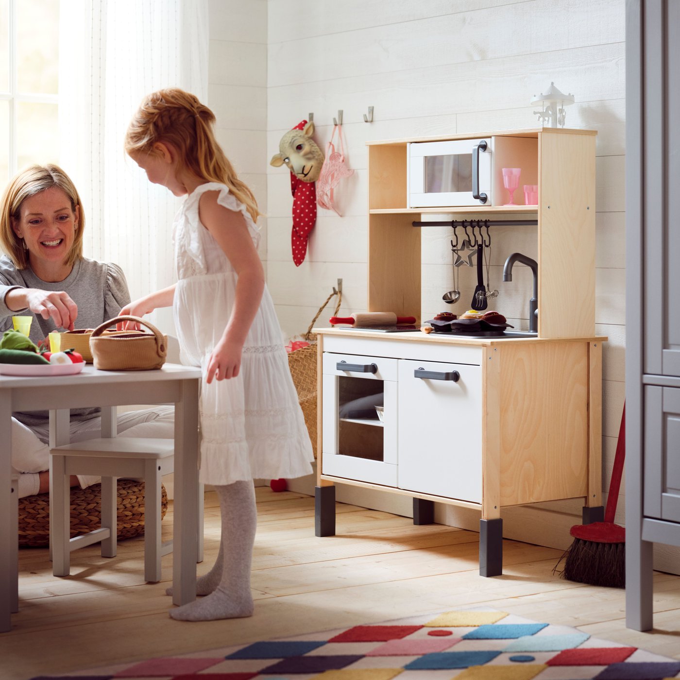A birch DUKTIG play kitchen in the childrens room