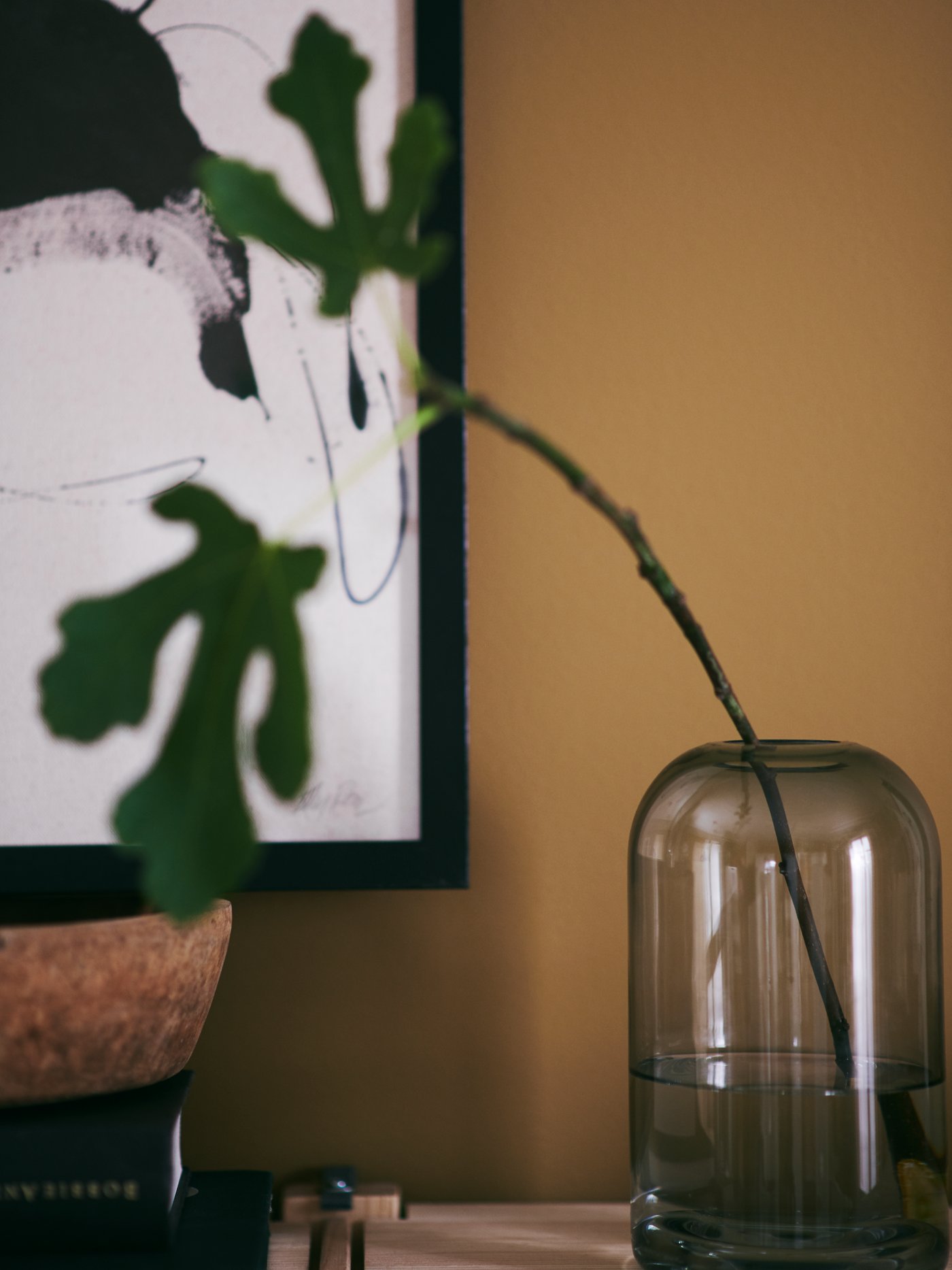 A DRÖMSK glass vase with a simple fig branch adds a calming touch of greenery.