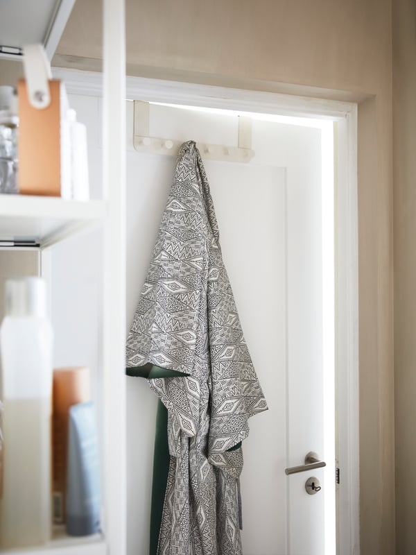 A white ENUDDEN hanger for door in the bathroom