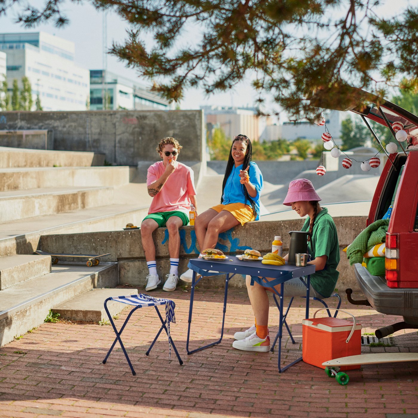 Three young people are getting ready for a festival with camping gear from STRANDÖN.