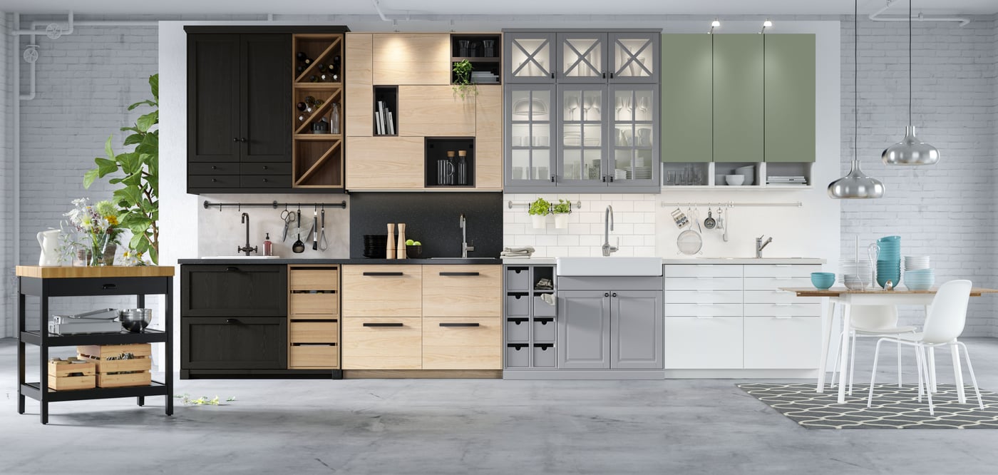 Several kitchens are lined up next to each other, each featuring different METOD fronts.