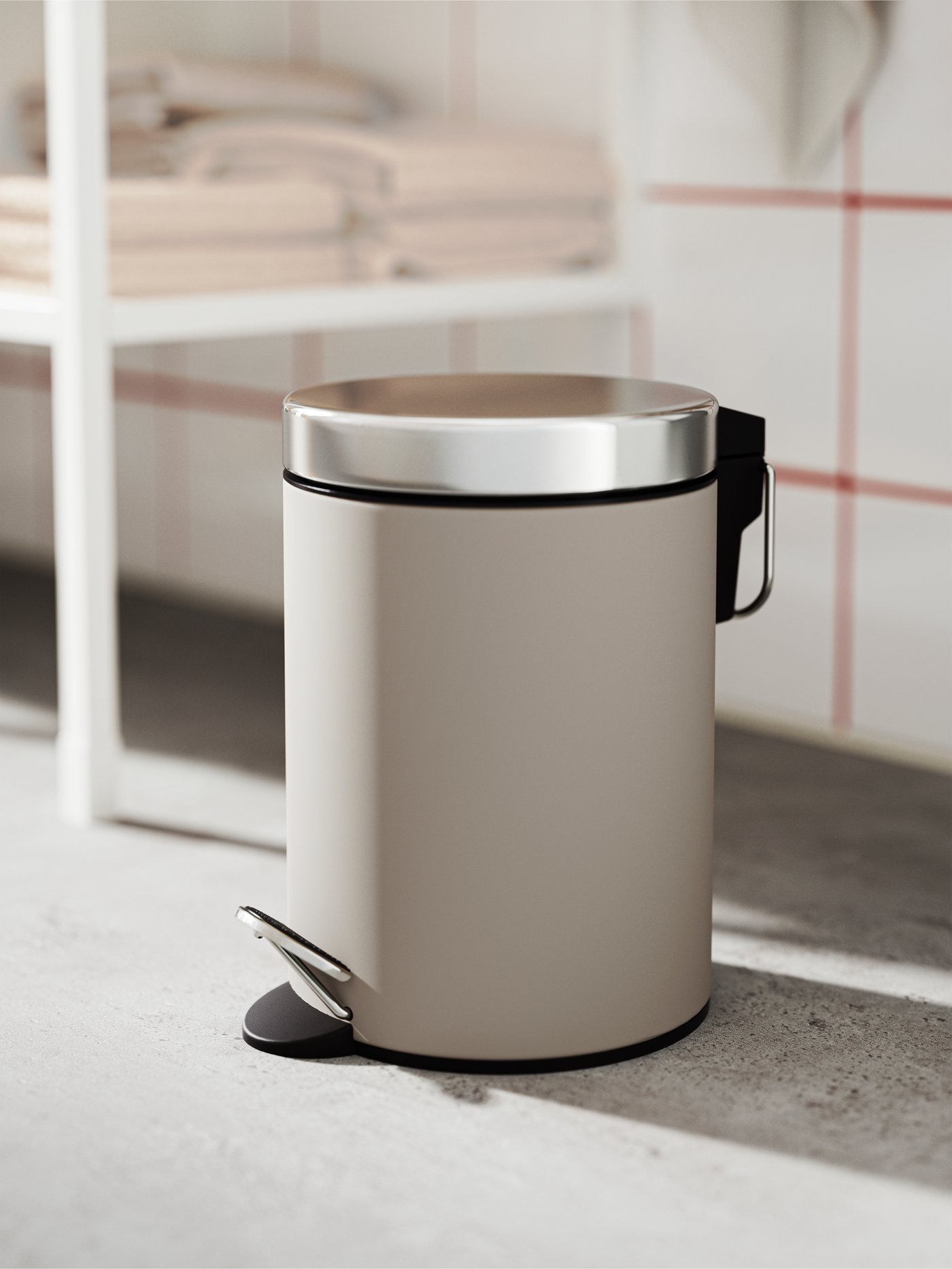A beige EKOLN waste bin