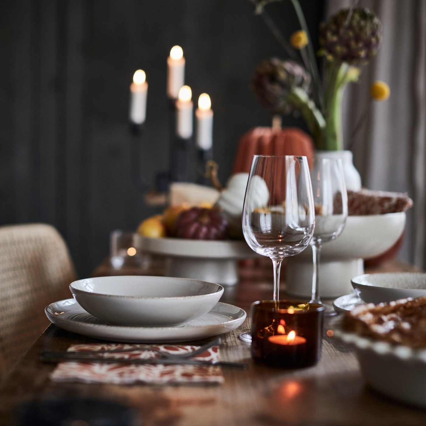 A white JUBLA unscented chandelier candle in the dining room