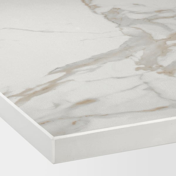 Close-up of a white countertop with a smooth matte finish and bold gray and beige veining.