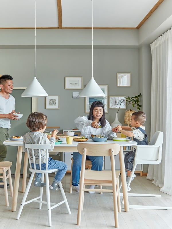 Family with small children on dining room chairs