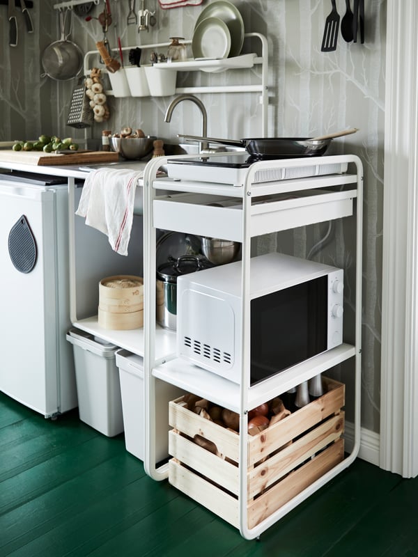 IKEA SUNNERSTA white storage unit holding a SUNNERSTA microwave and next to a SUNNERSTA mini kitchen unit.
