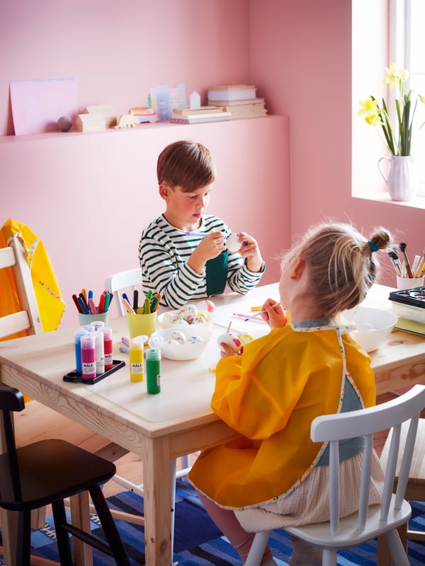 A white/transparent SKVALLRA desk pad in the childrens room