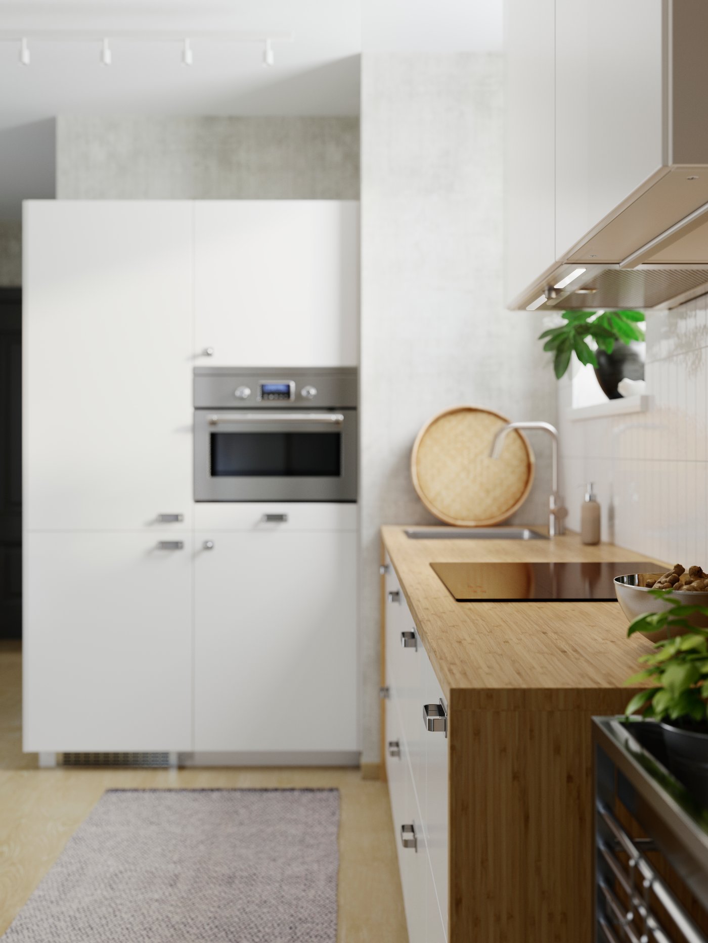 Side view of a custom-made HOLMARED worktop made of bamboo veneer, framed by white cabinets. The L-shaped kitchen is decorated in white.