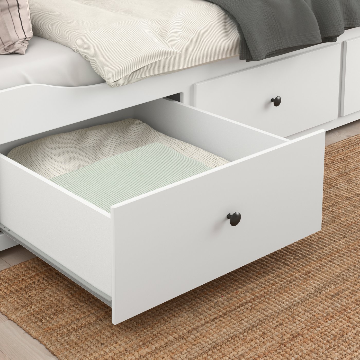 A white HEMNES day-bed frame with 3 drawers in the bedroom