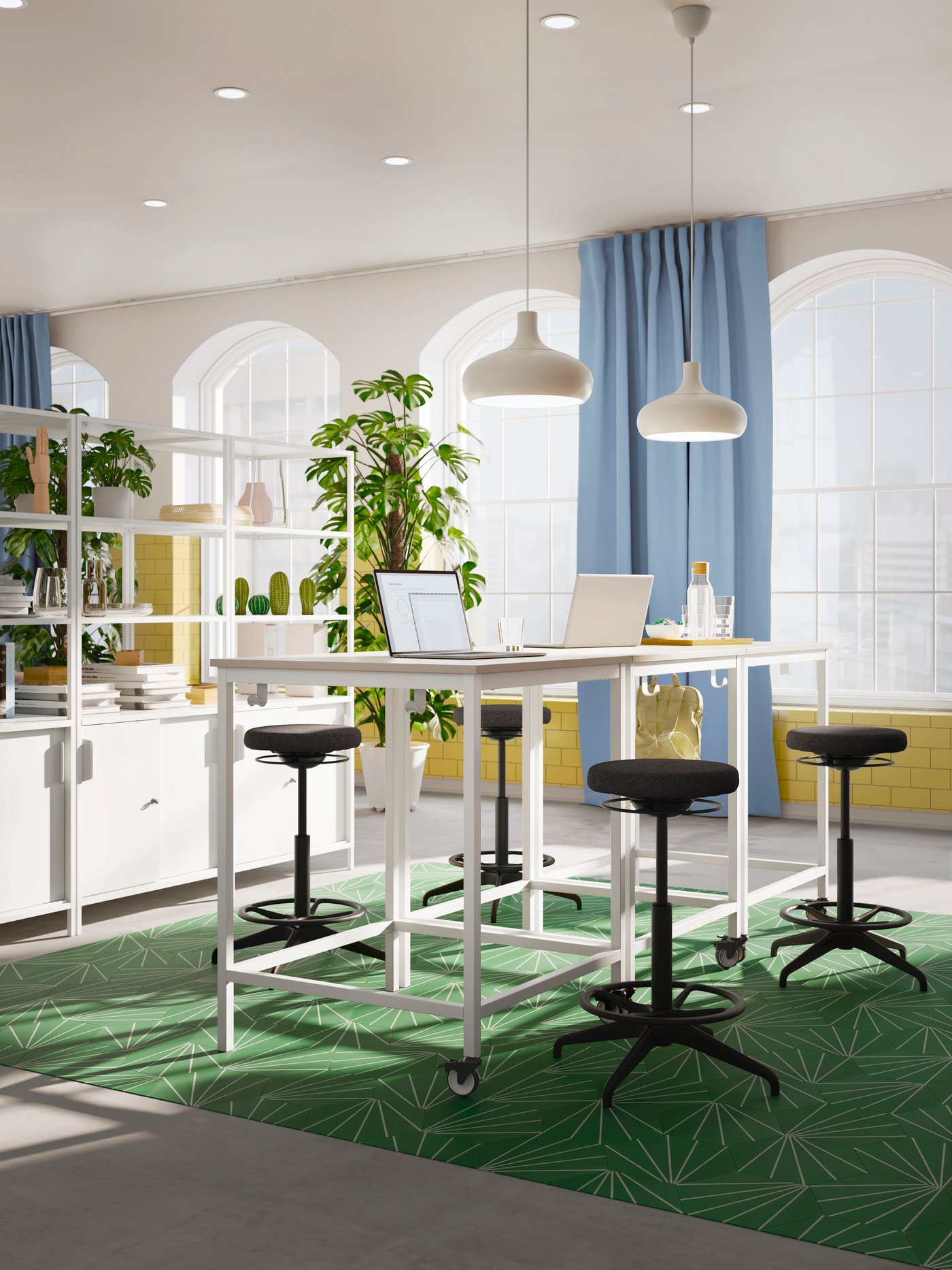 Dark gray LIDKULLEN sit-stand supports around TROTTEN tables in a light, spacious office with blue BENGTA blackout curtains.