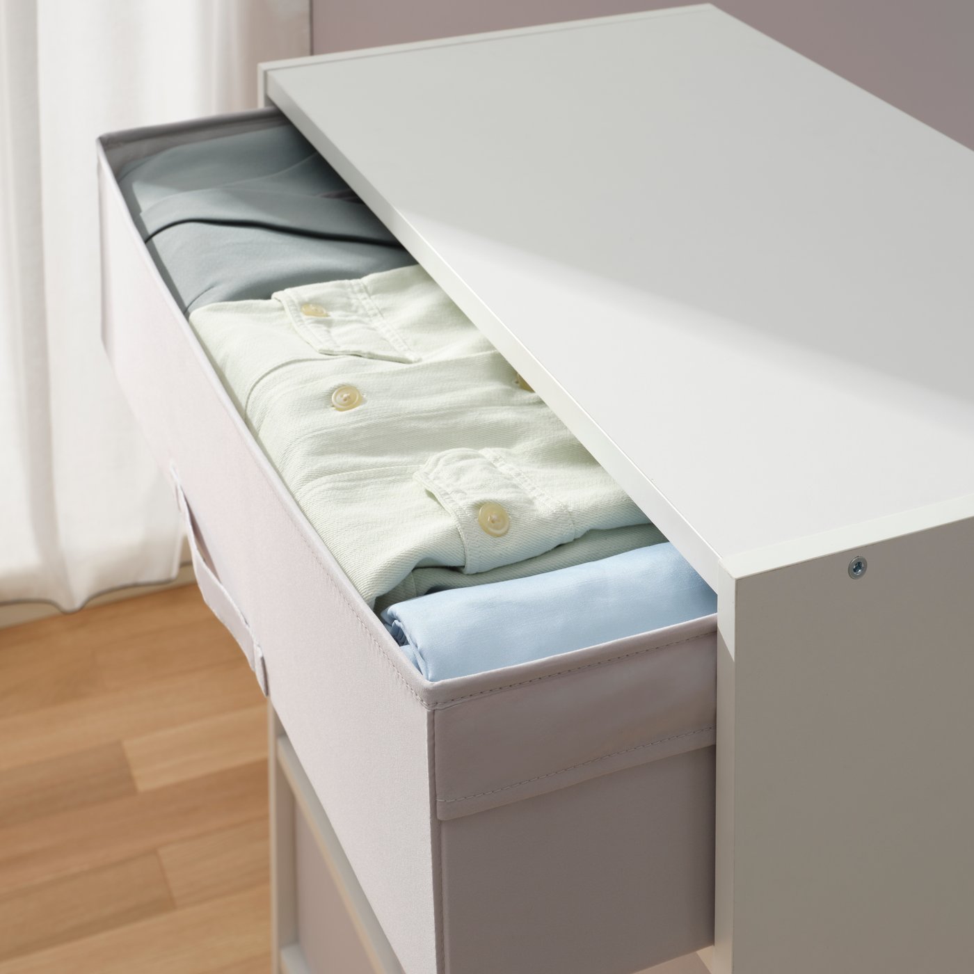 A white/light grey BRUKSVARA storage unit with 4 boxes