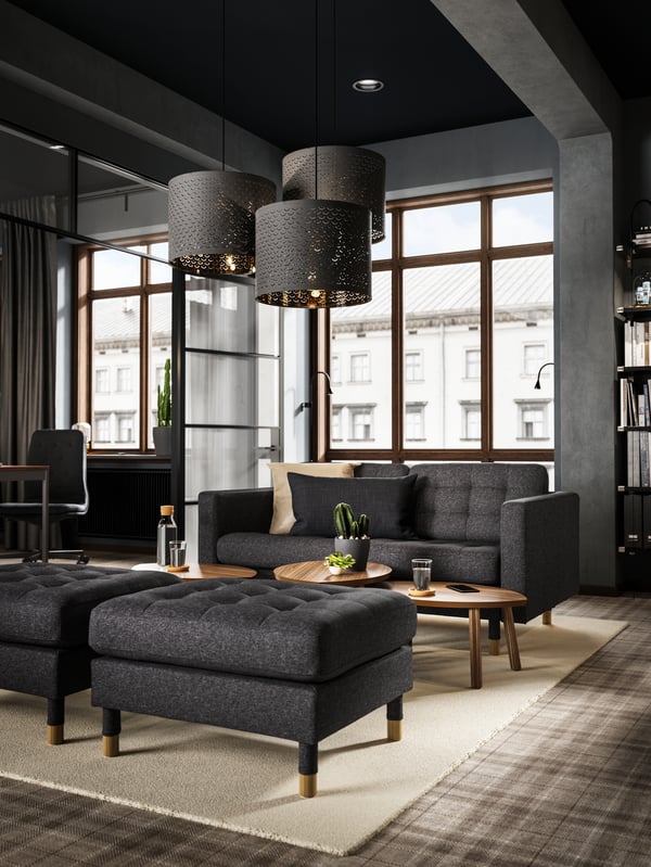 A living room with a large window and LANDSKRONA sofas in grey