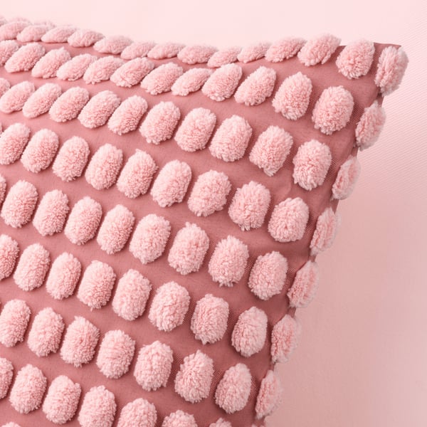 A light pink SVARTPOPPEL cushion cover