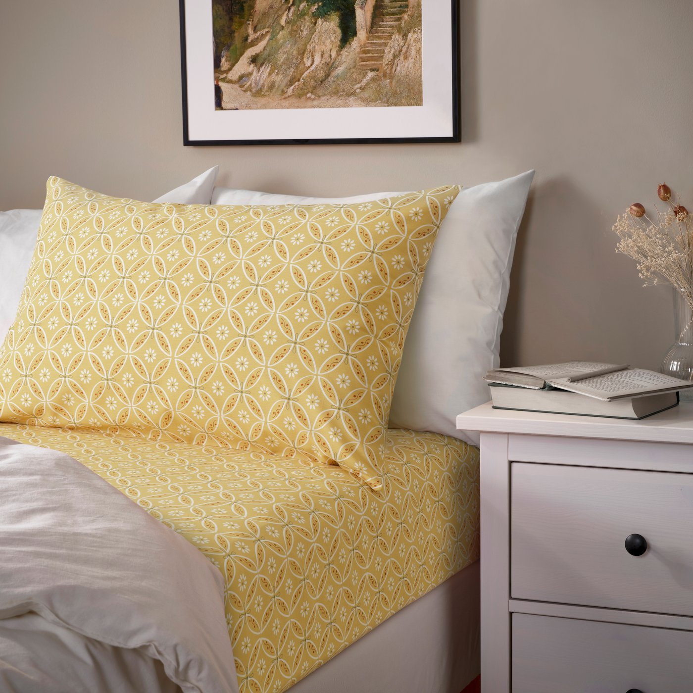 An yellow/multicolour HAMNSENAP flat sheet and 2 pillowcase in the bedroom