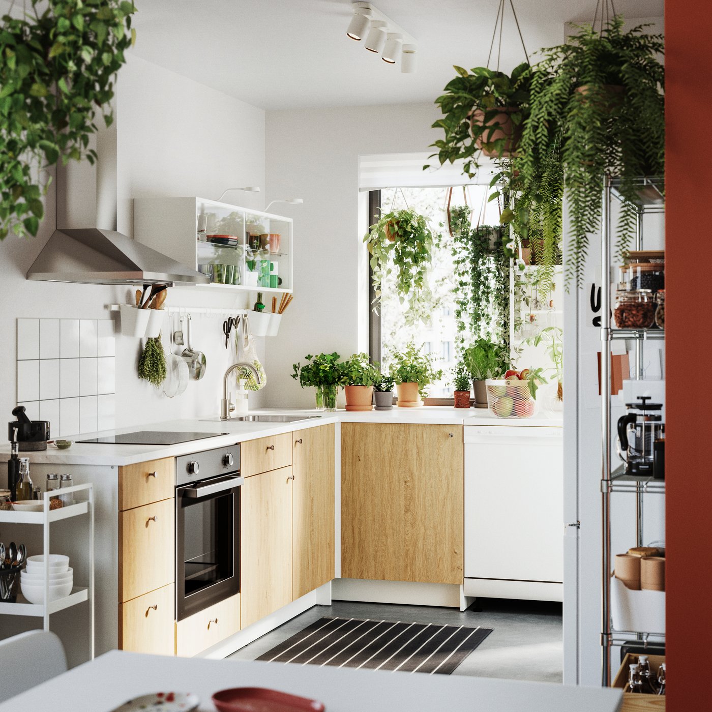 A modern kitchen features KNOXHULT base cabinets with doors and a front in a warm wood finish, surrounded by greenery.