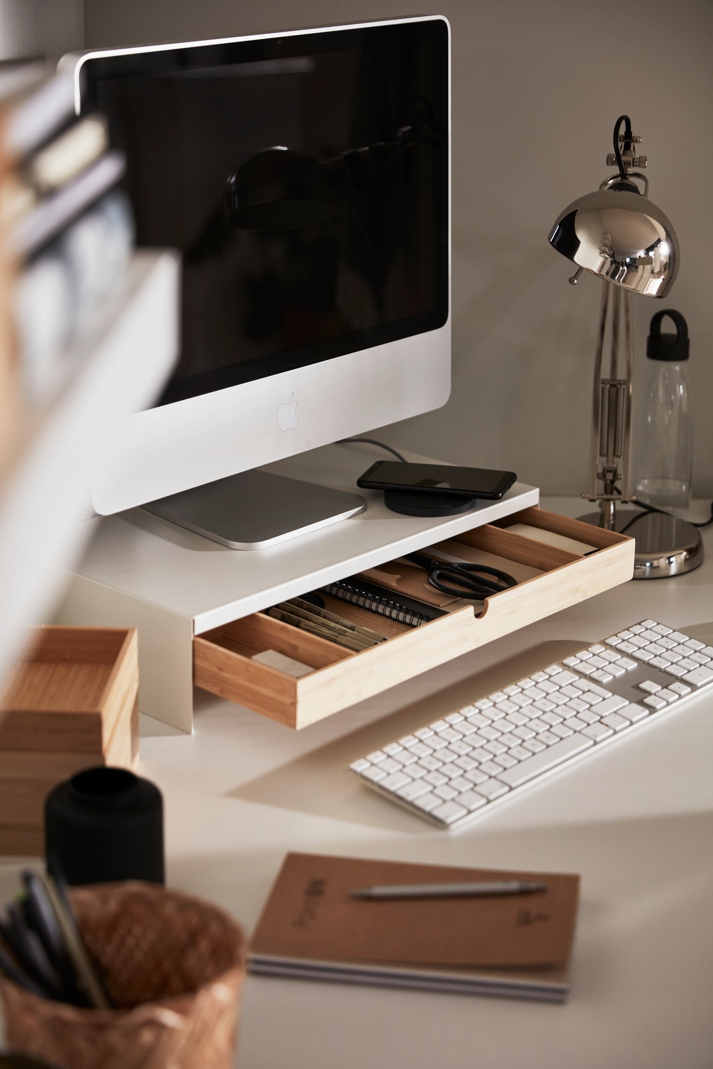 A white ELLOVEN monitor stand with drawer