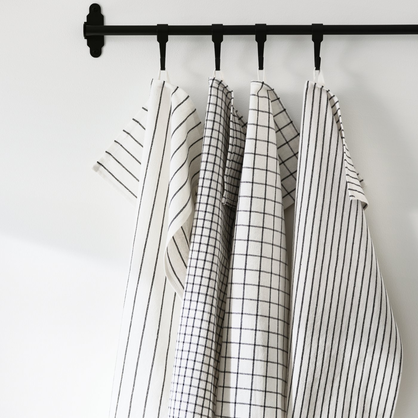 A white/dark grey/patterned RINNIG tea towel