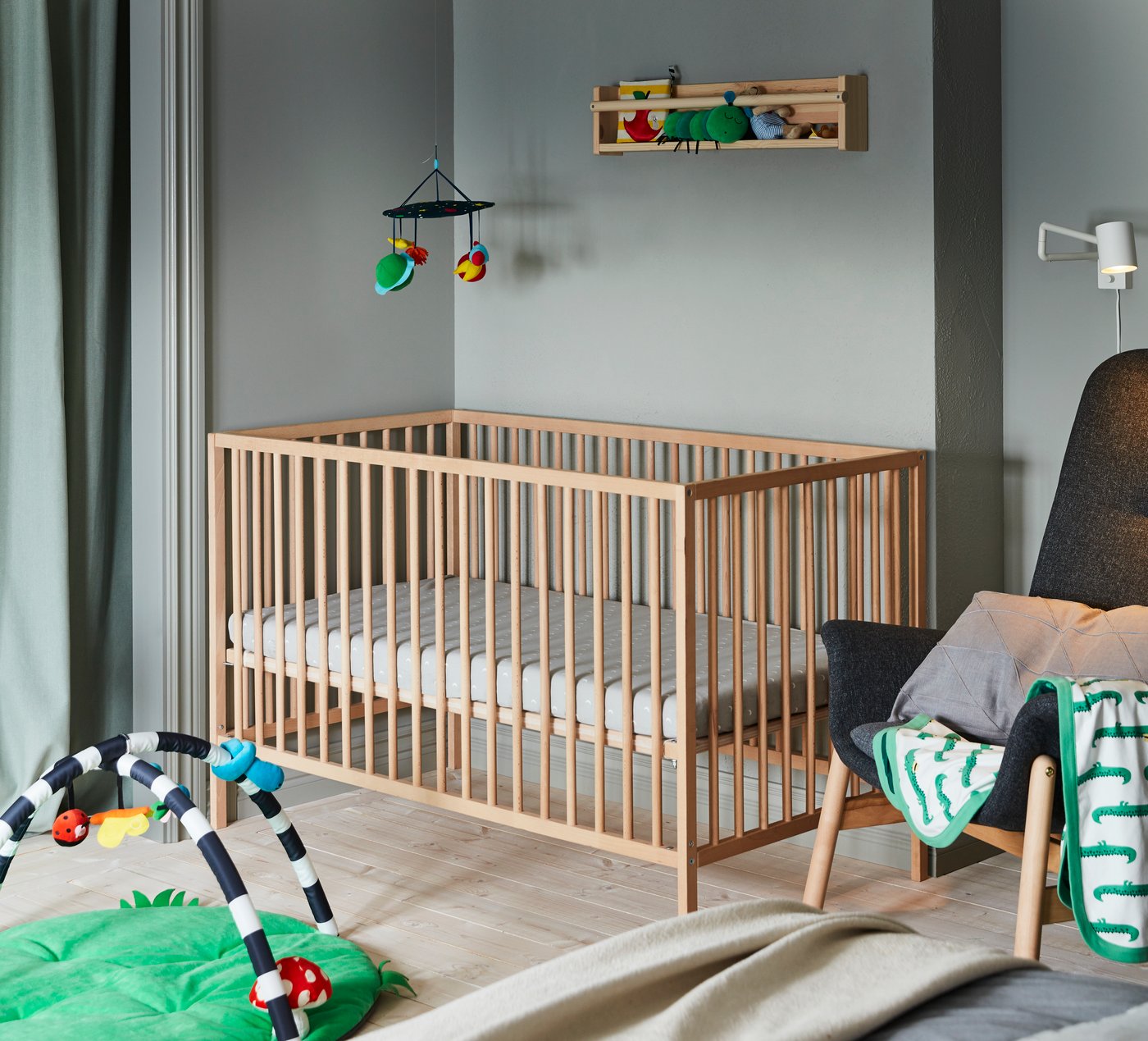 A Gunnared dark grey VEDBO high-back armchair in the childrens room