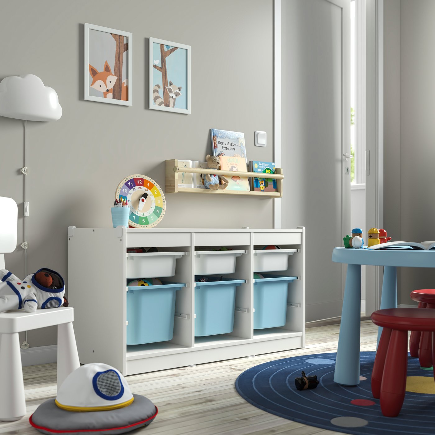 A white white/light blue TROFAST storage combination with boxes