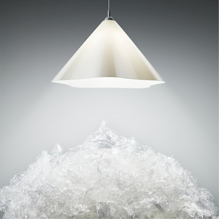 Plastic: White plastic pellets beneath a hanging lamp.					