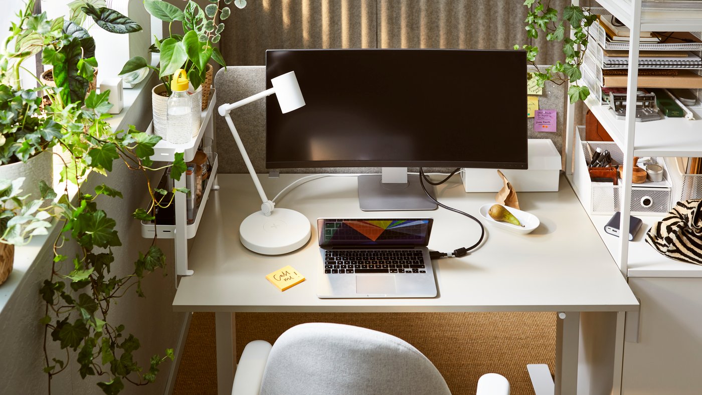 A white NYMÅNE work lamp with wireless charging