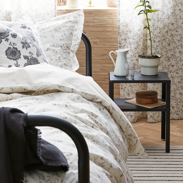 A black FYRESDAL day-bed frame in the bedroom