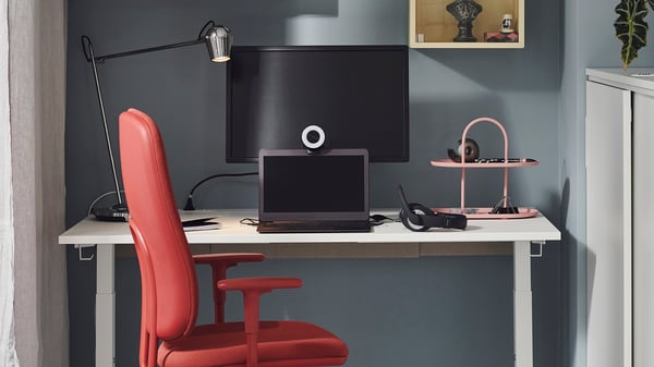 An electric white MITTZON desk sit/stand in the home office