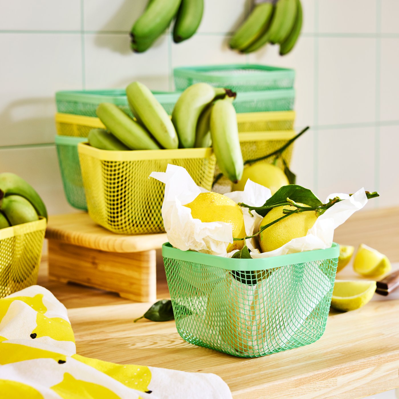 Lemons and bananas stored in green and yellow mesh IKEA 365+food storage baskets.